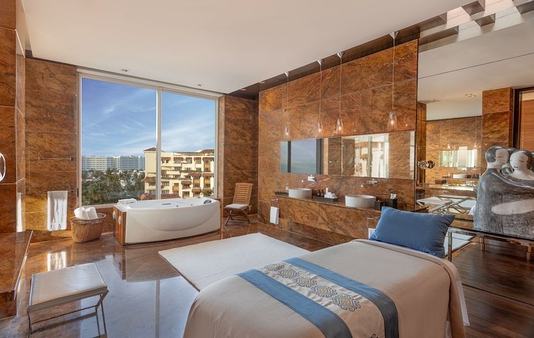 A large room with a large tub and a large window