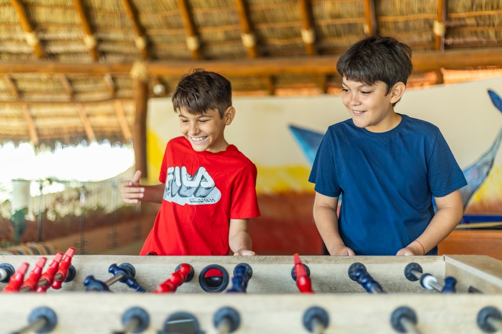 Two boys playing foosball