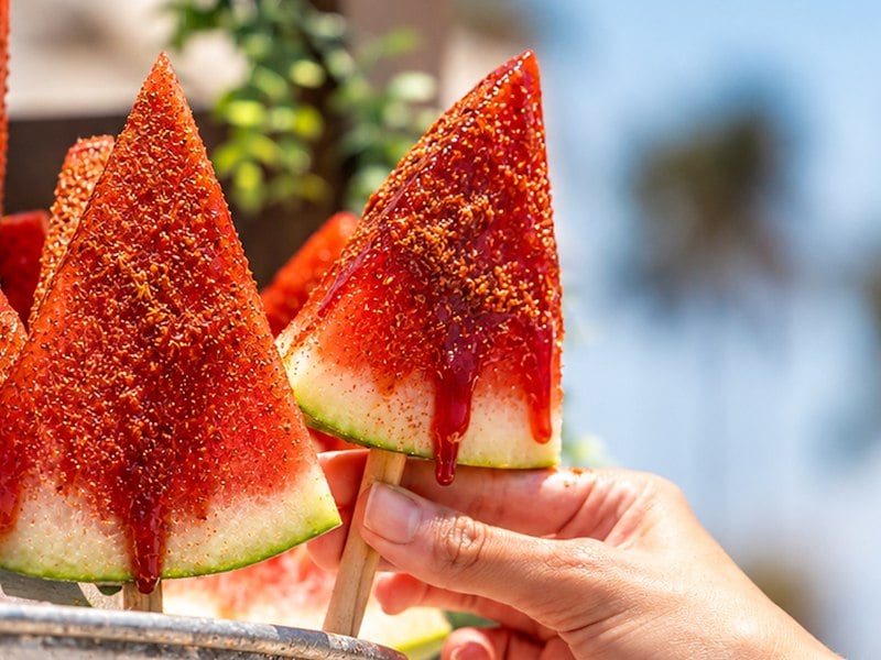 A hand holding a watermelon popsicle