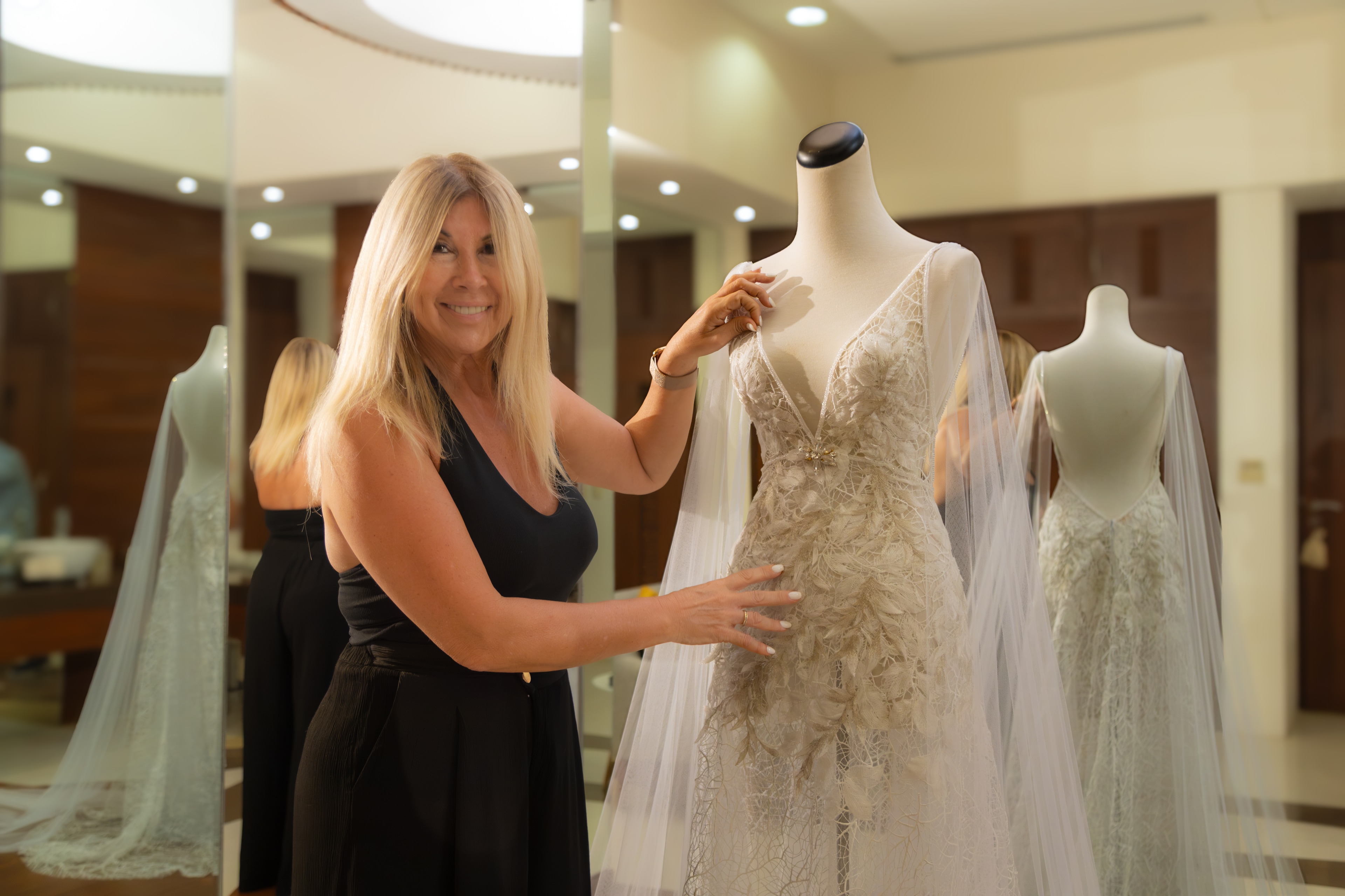 A woman standing next to a mannequin