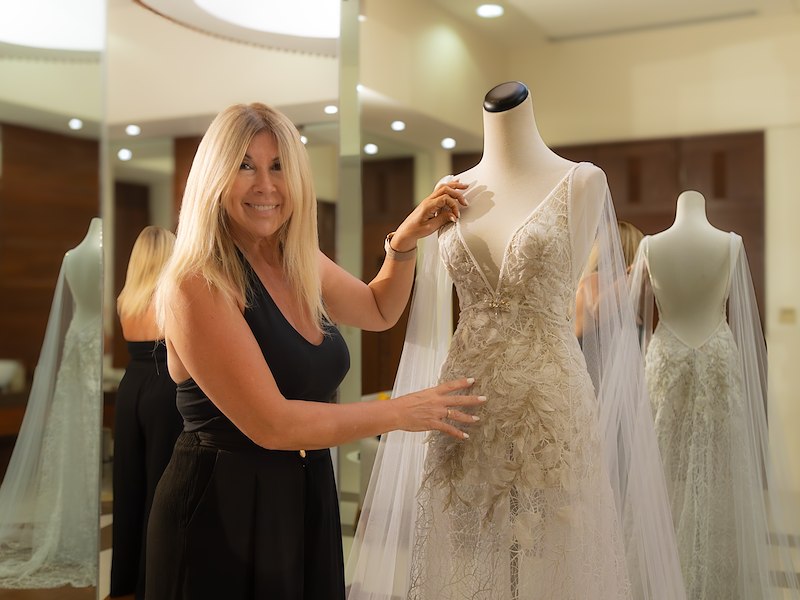 A woman standing next to a mannequin