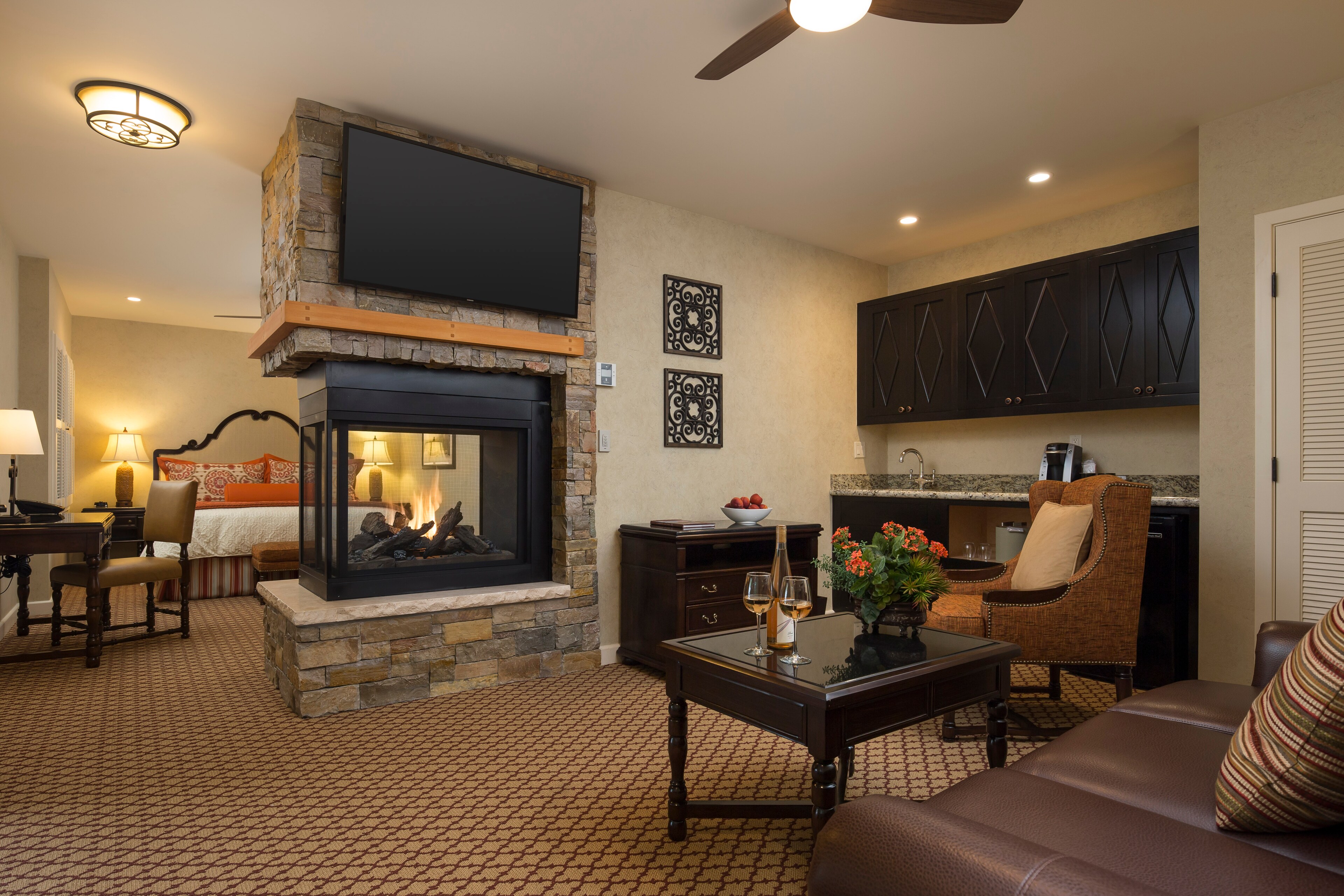 A hotel room with a fireplace and a television, Casa Munras Garden Hotel & Spa, Monterey, California