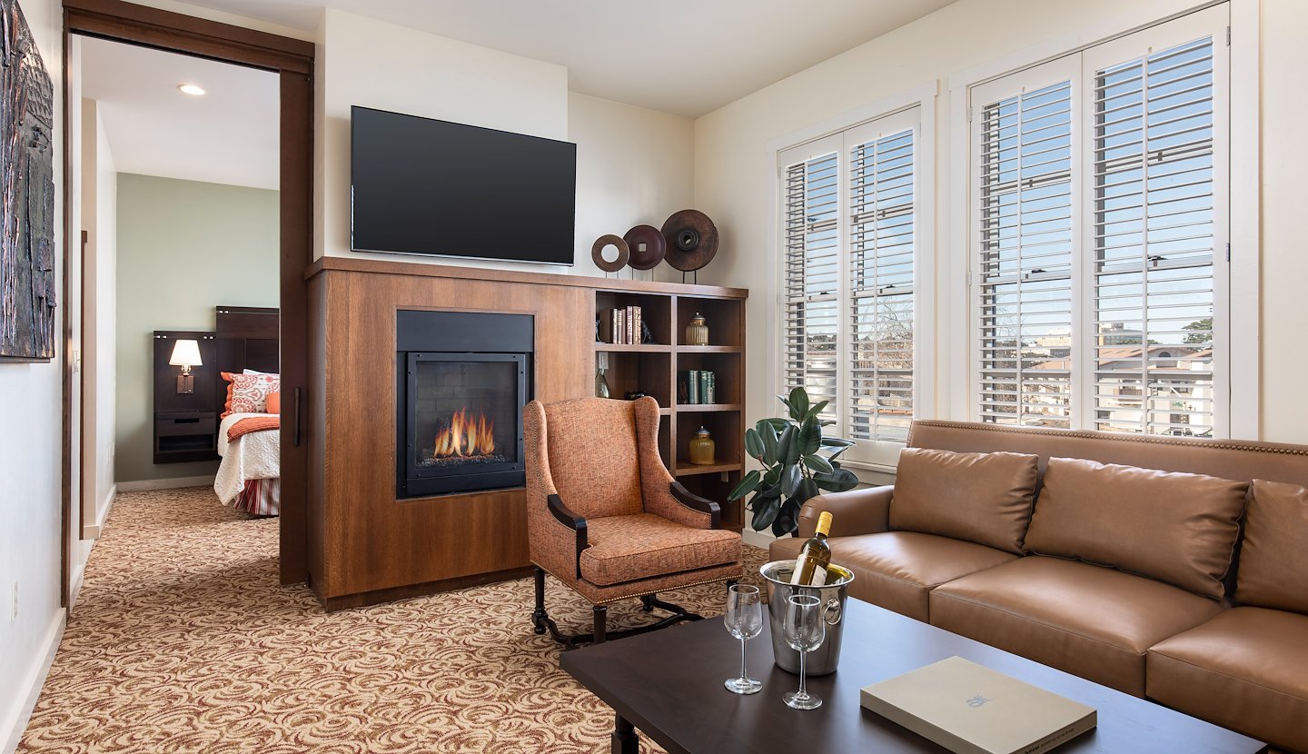 A bedroom with two beds and a fireplace, Casa Munras Garden Hotel & Spa, Monterey, California
