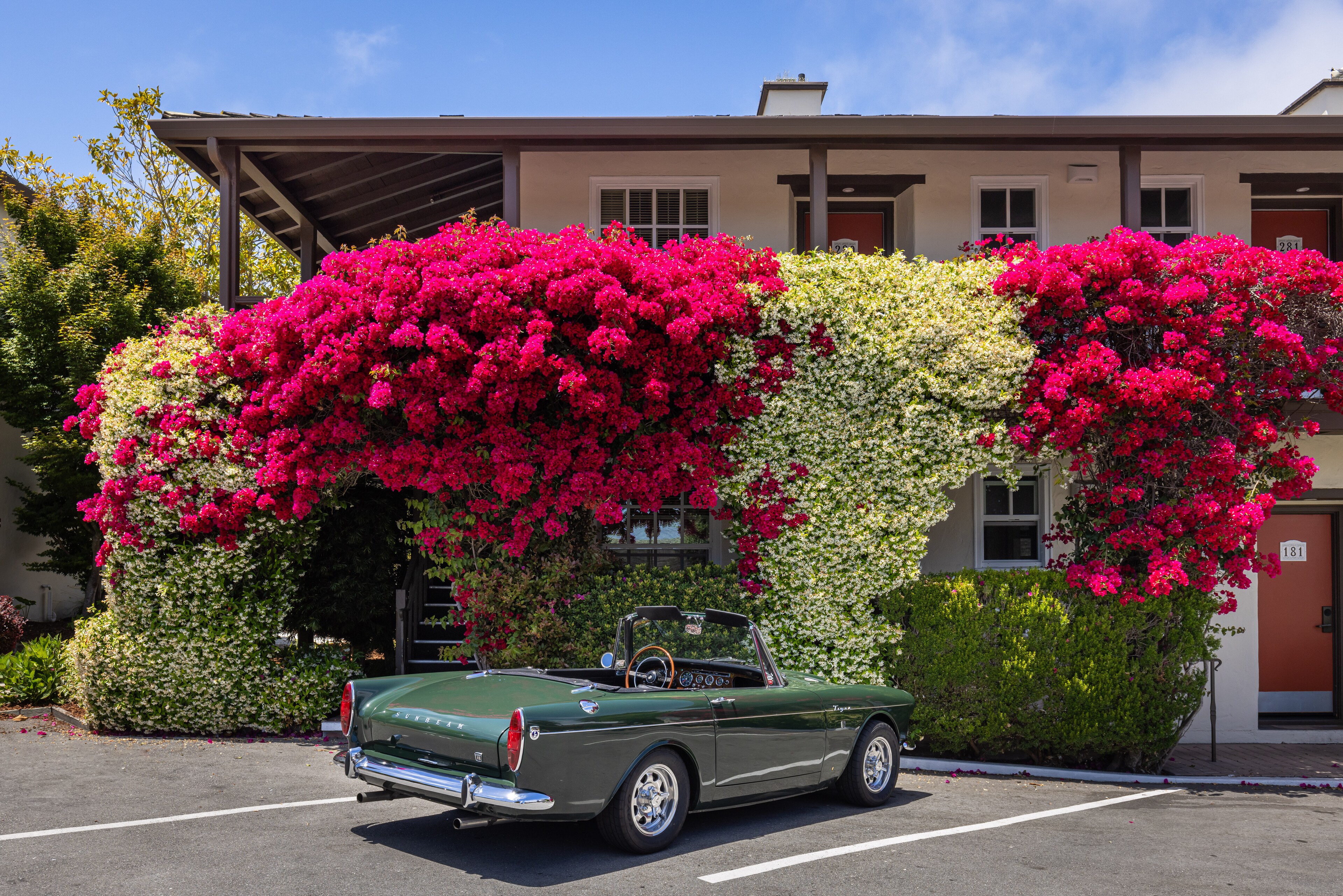 A car parked in front of a building with flowers, Casa Munras Garden Hotel & Spa, Monterey, California