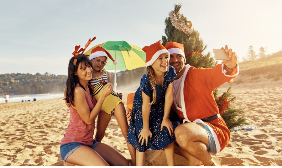 A group of people posing for a picture on a beach