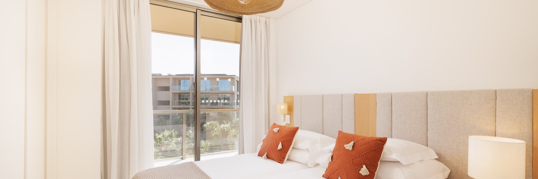 Serene Bedroom Scene with a Comfortable Bed of Flamingos Salgados, Albufeira