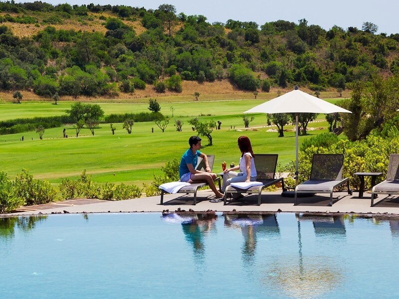Couple enjoying the moment near pool at morgado golf country club