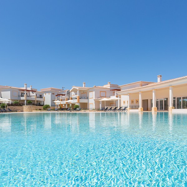 Family or friends can relax at the Outdoor Pool in front of villa at NAU Salema Beach Village