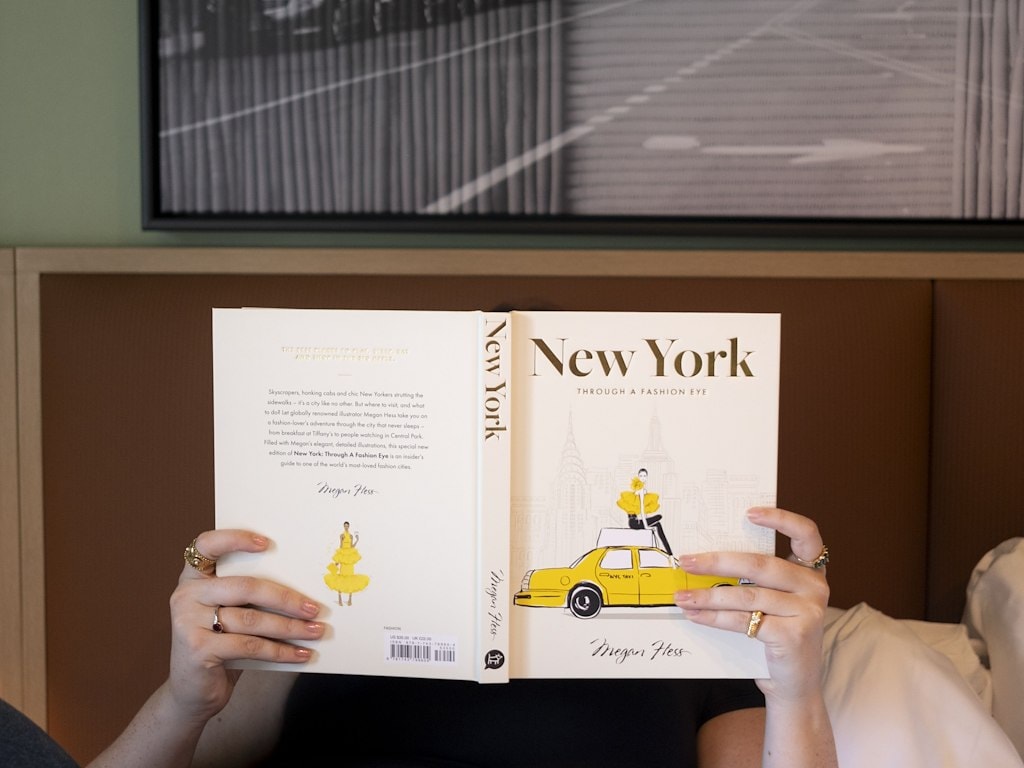 A person reading a book about New York