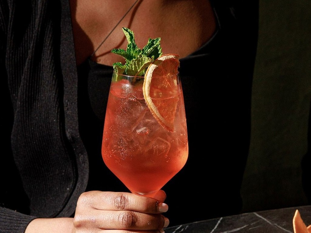 A woman holding a drink