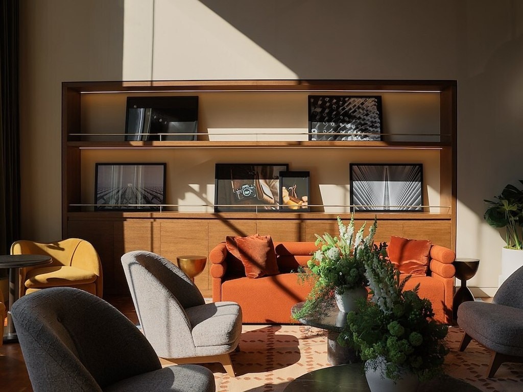 A room with a couch and tv on the wall