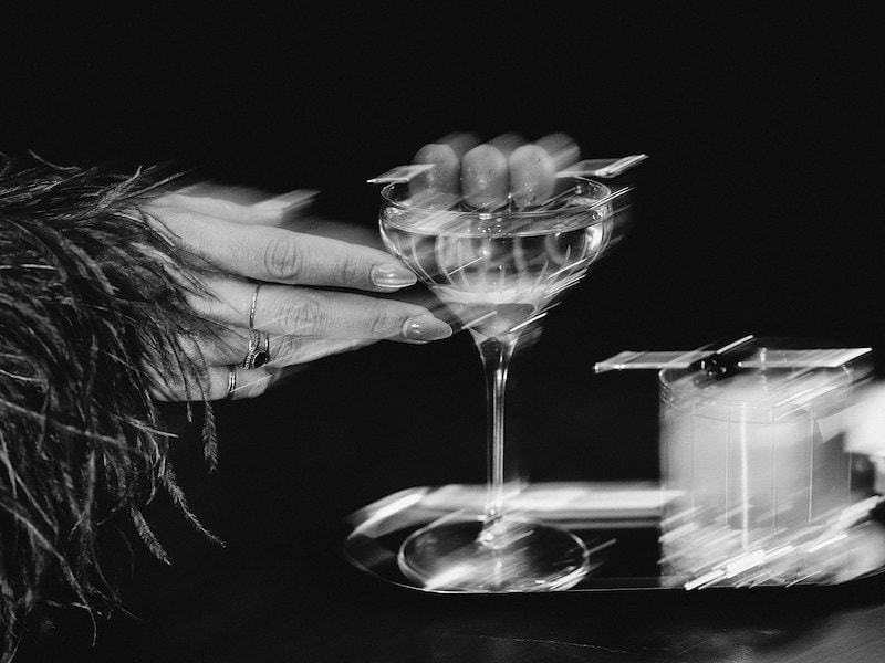 A hand holding a glass