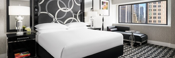 A Hotel Room With A Cozy Bed And Photo Pillow at The Muse New York