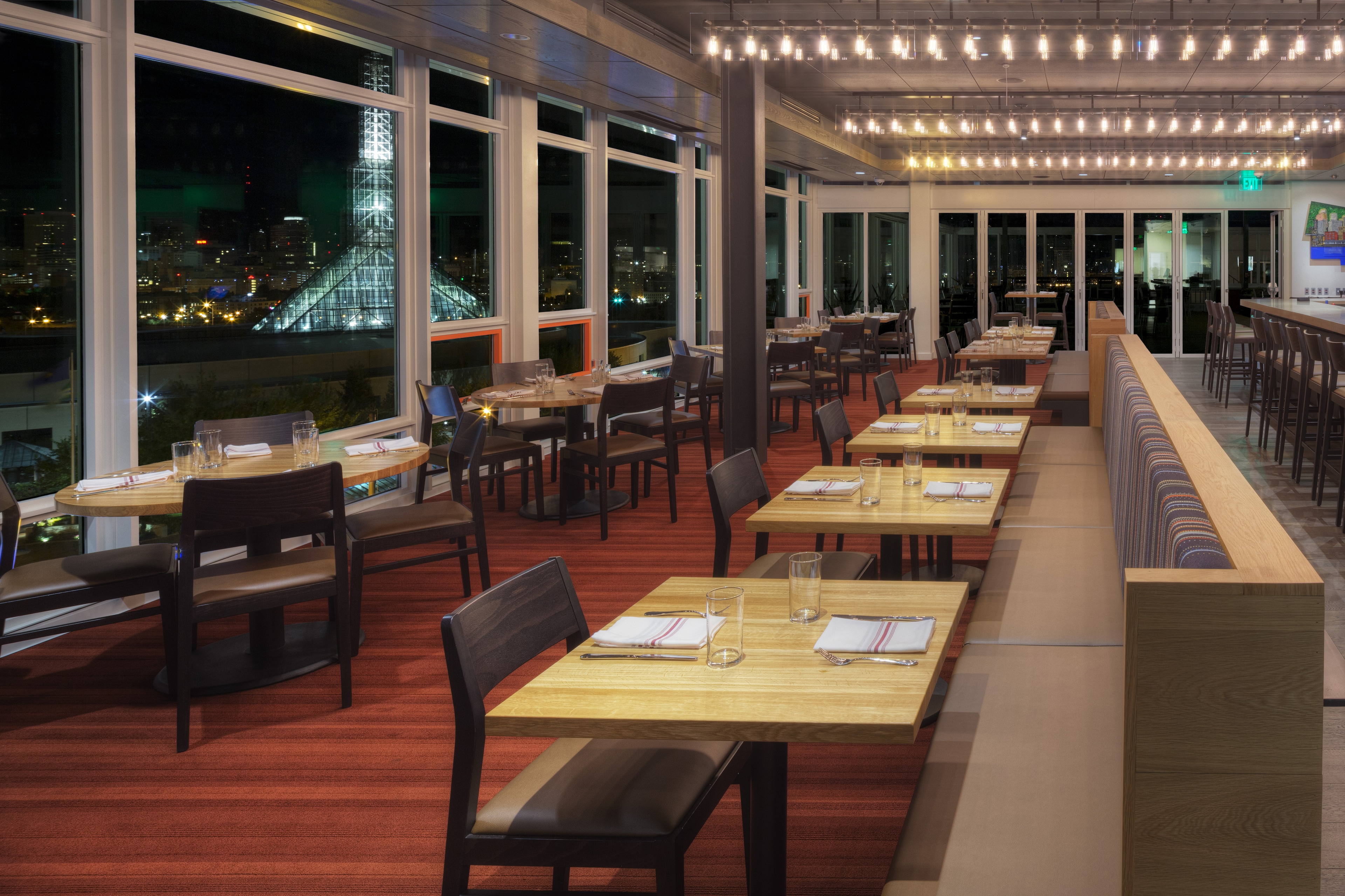 a dining area with tables and chairs set for dinner