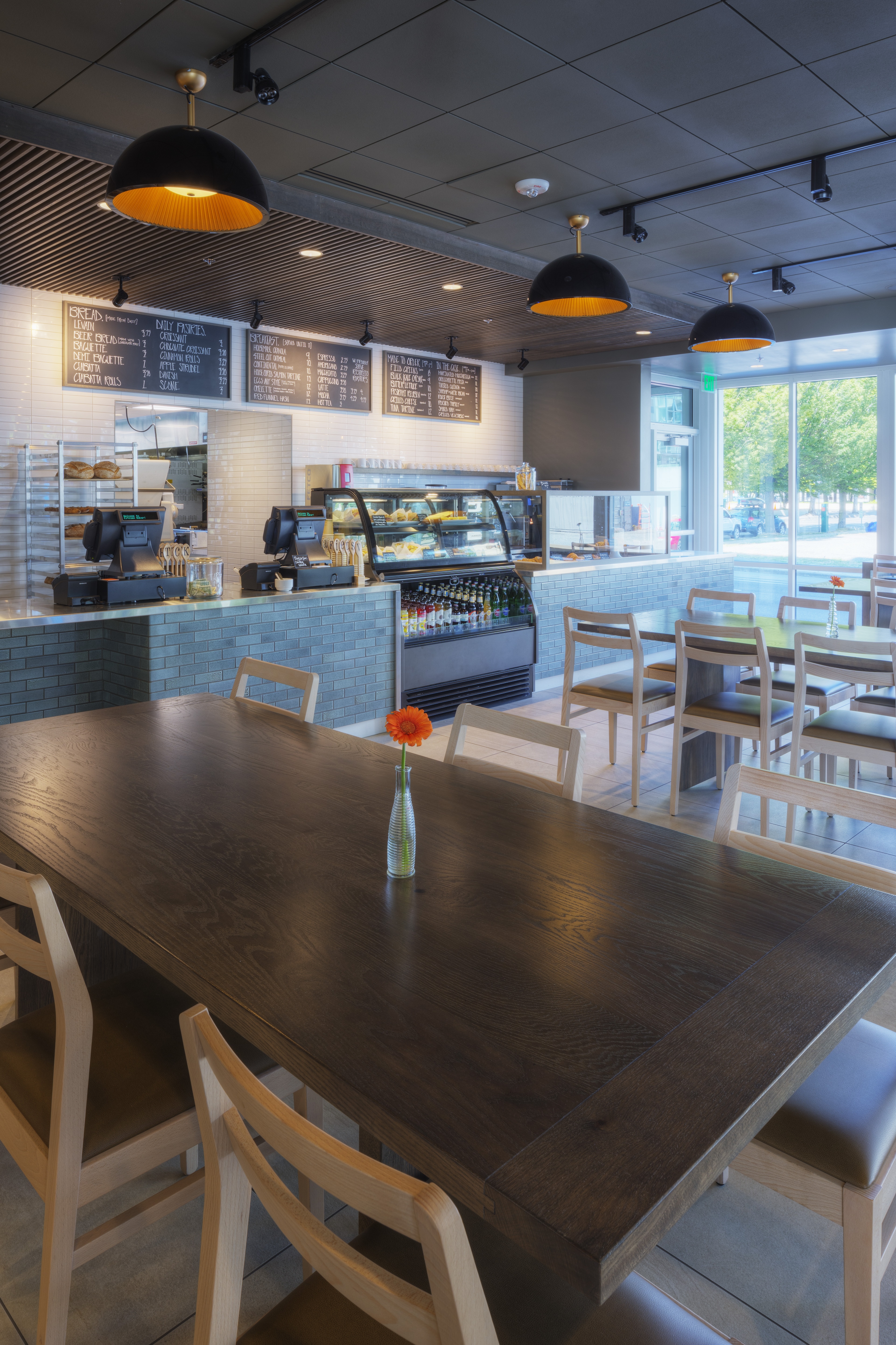 a dining area with a counter and tables