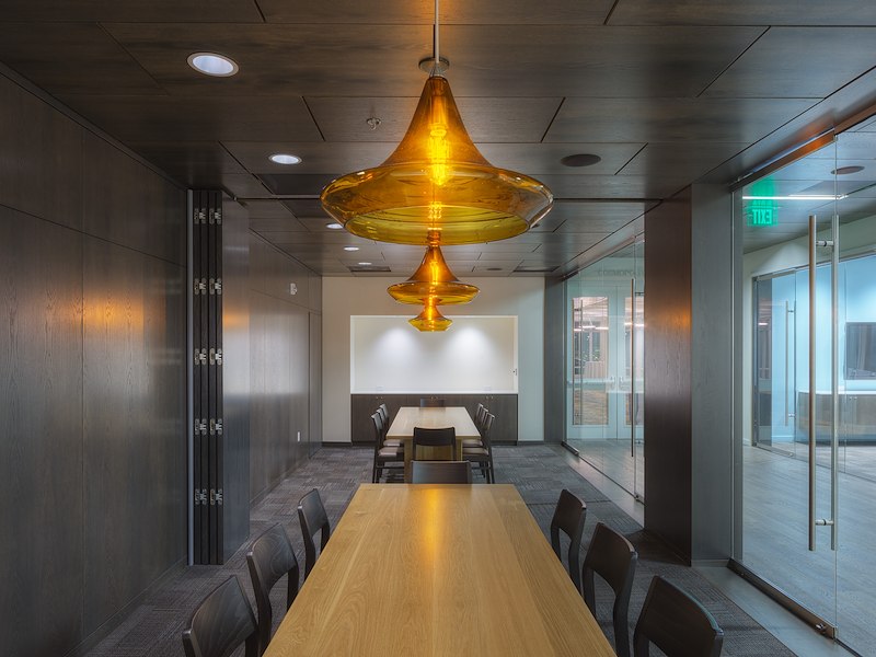 a long wooden table with chairs in a meeting room
