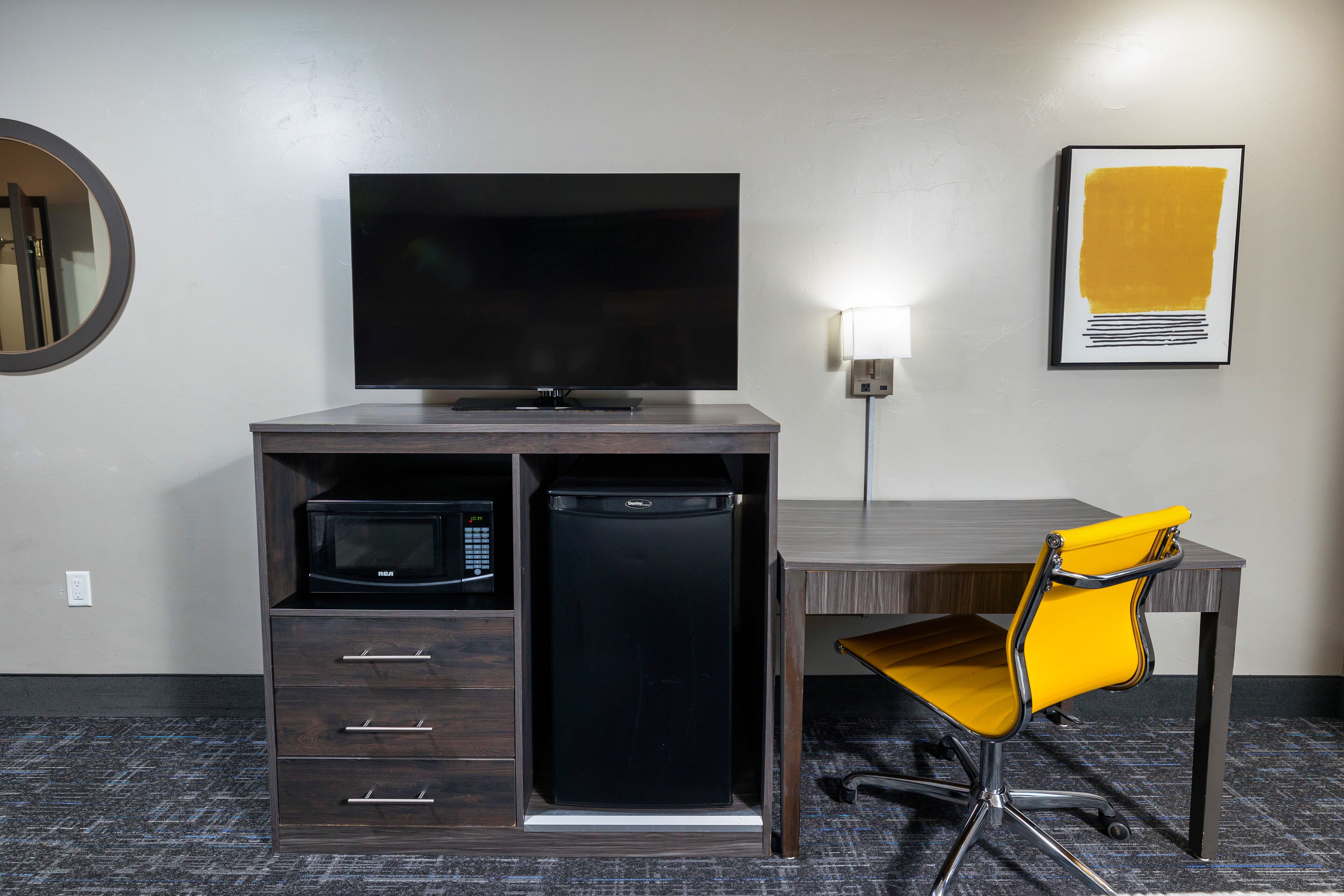 A hotel room detail with a TV, mini fridge, microwave, and desk. Hotel J, Green Bay, Wisconsin.