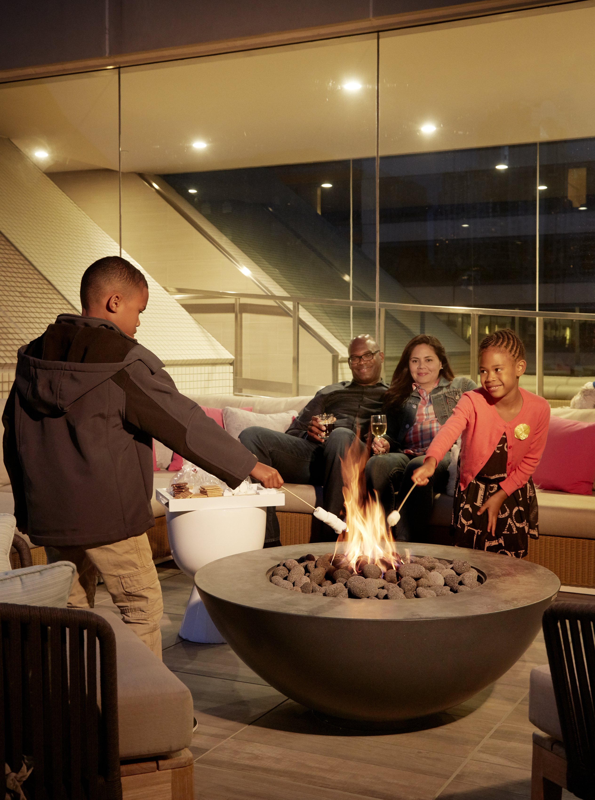 Guests enjoy roasting marshmallows at Hotel Nikko San Francisco's cozy fire pit