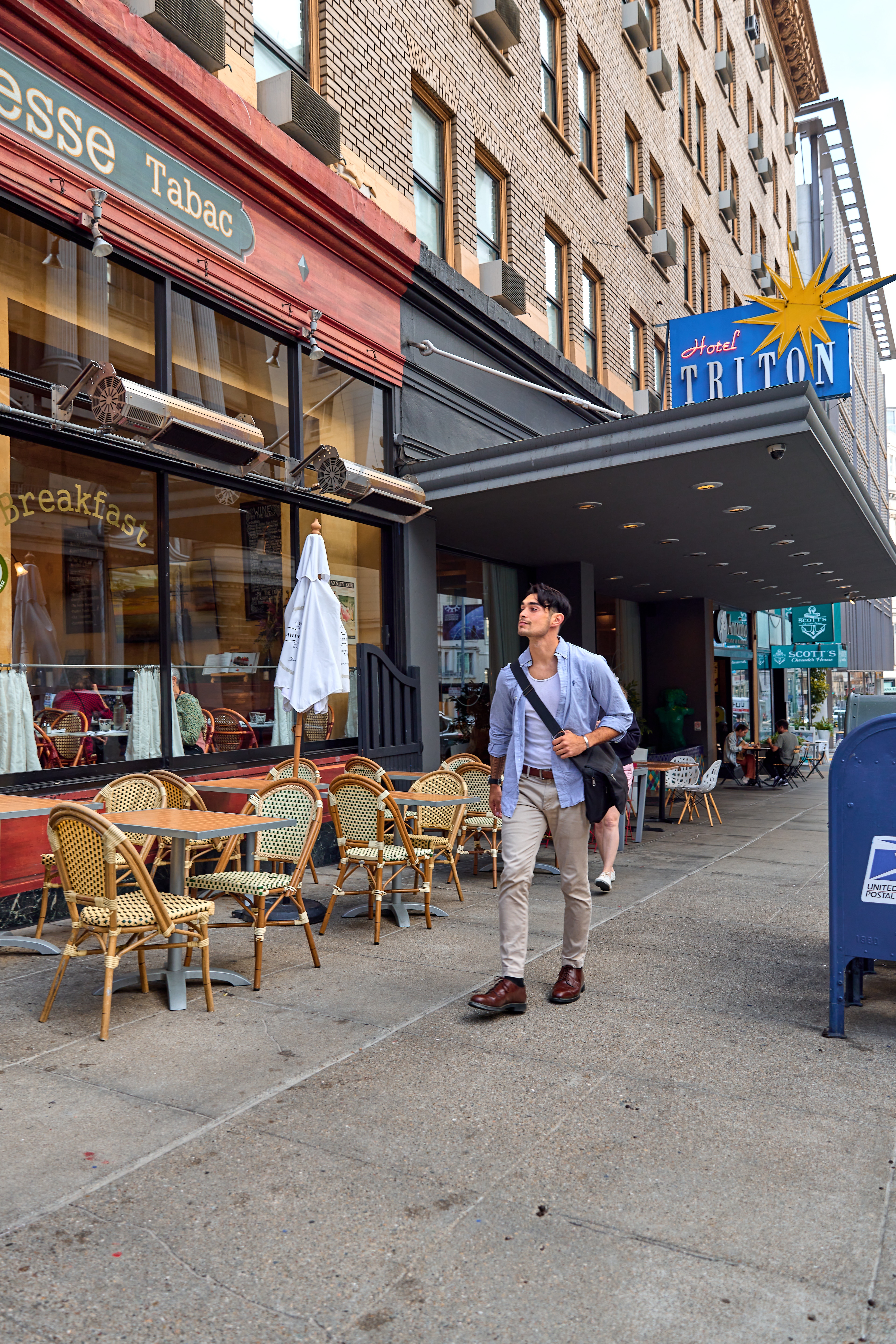 The exterior of Hotel Triton with a man walking in front of it