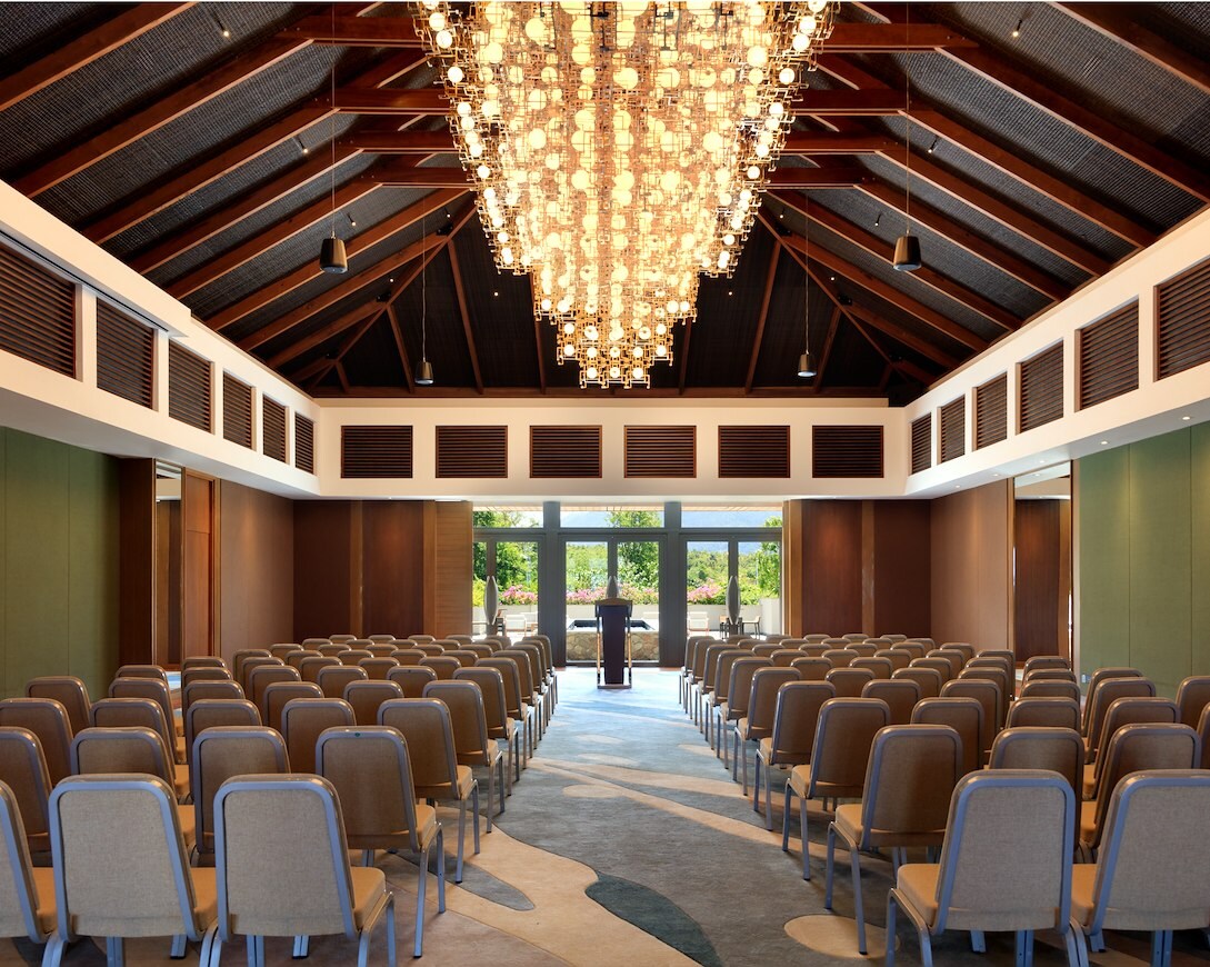 Medium-sized ballroom with fancy lighting and plenty of seating.