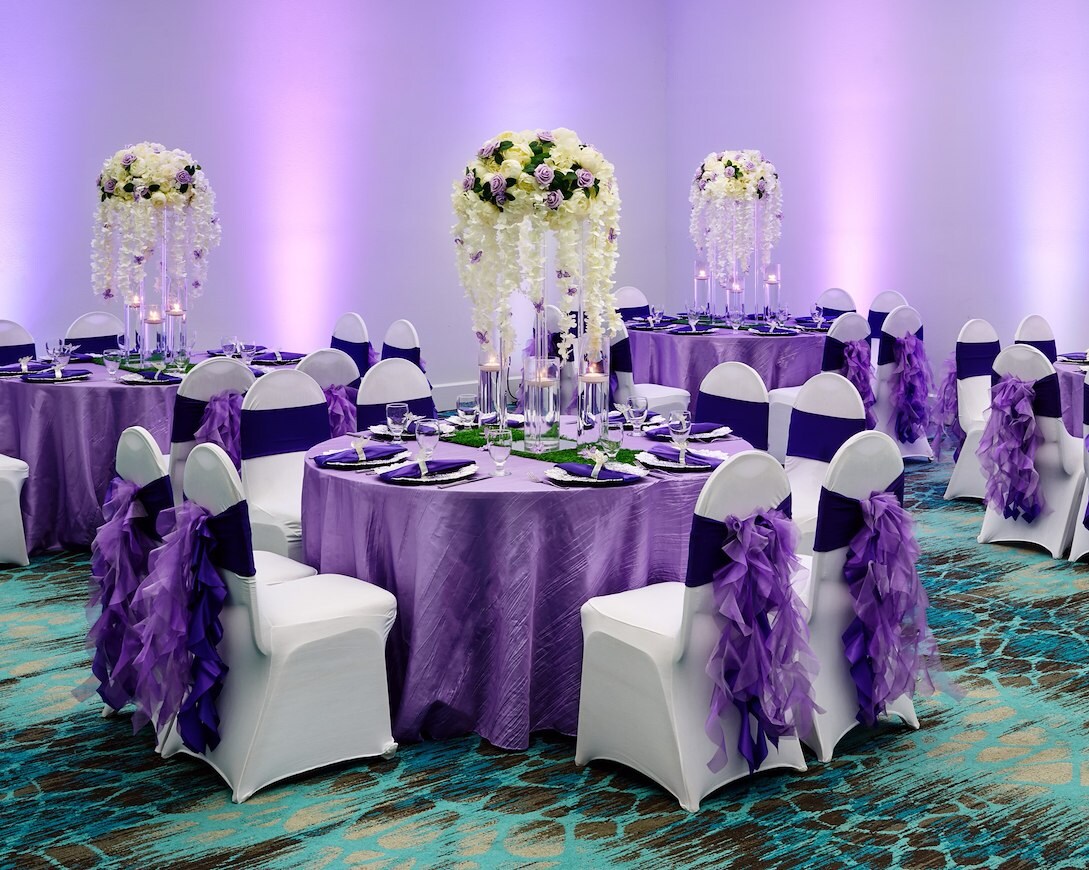Banquet room decorated for a purple-themed wedding
