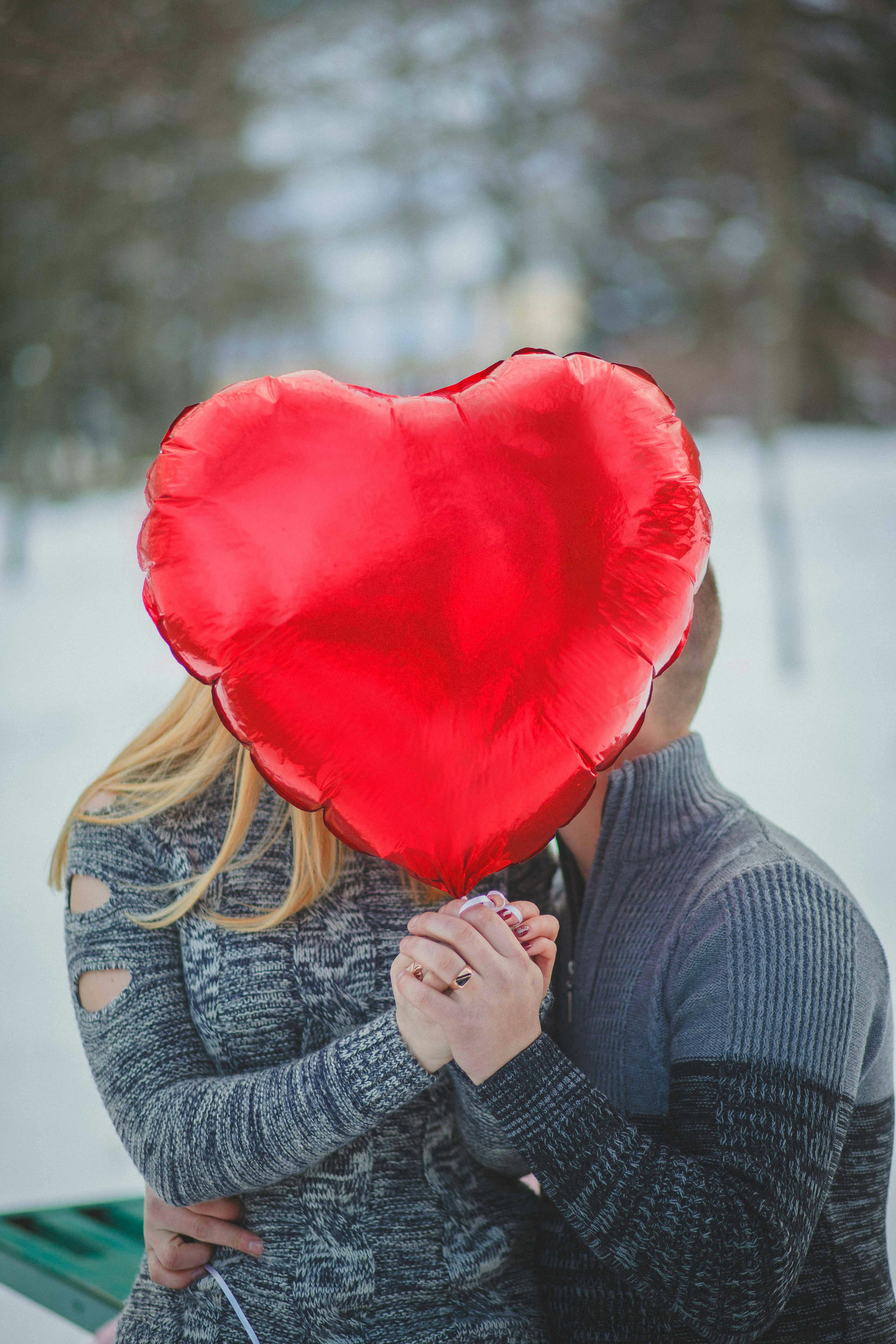 A man and woman kissing in the snow