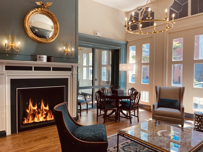 A room with a fireplace and a round table