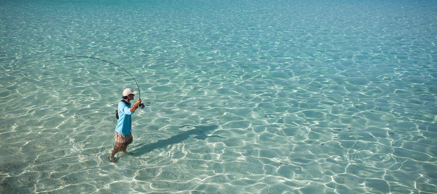 Fly fishing in clear Caribbean waters near Placencia, Belize
