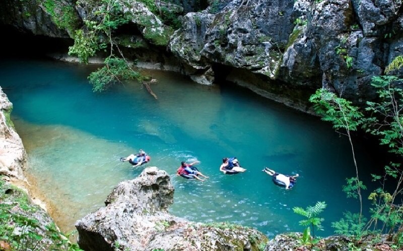 A group of people floating in a river