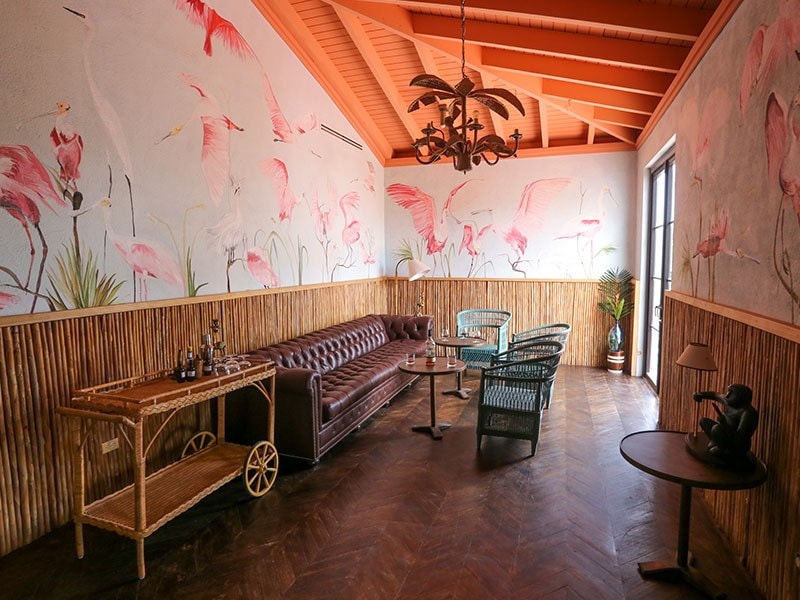 A room with a couch and chairs