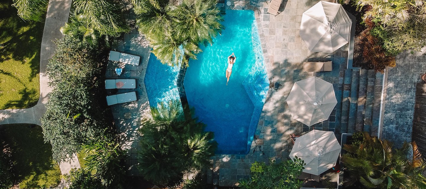 Aerial view of a serene Ka'ana Belize Resort pool surrounded by greenery in San Ignacio Cayo 