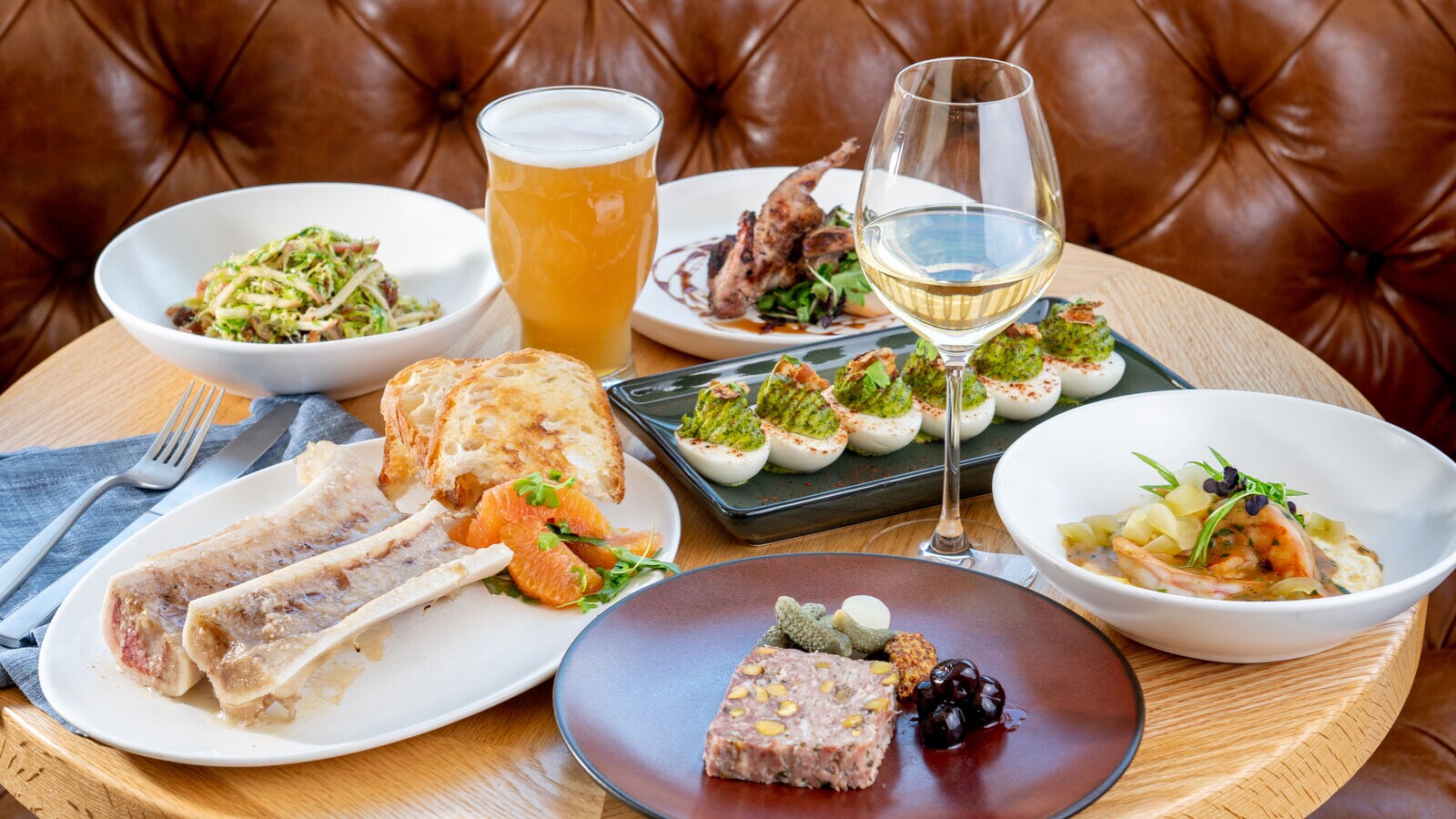 An interior features stylish seating and décor at Elm & Good Restaurant, Dallas, Texas.