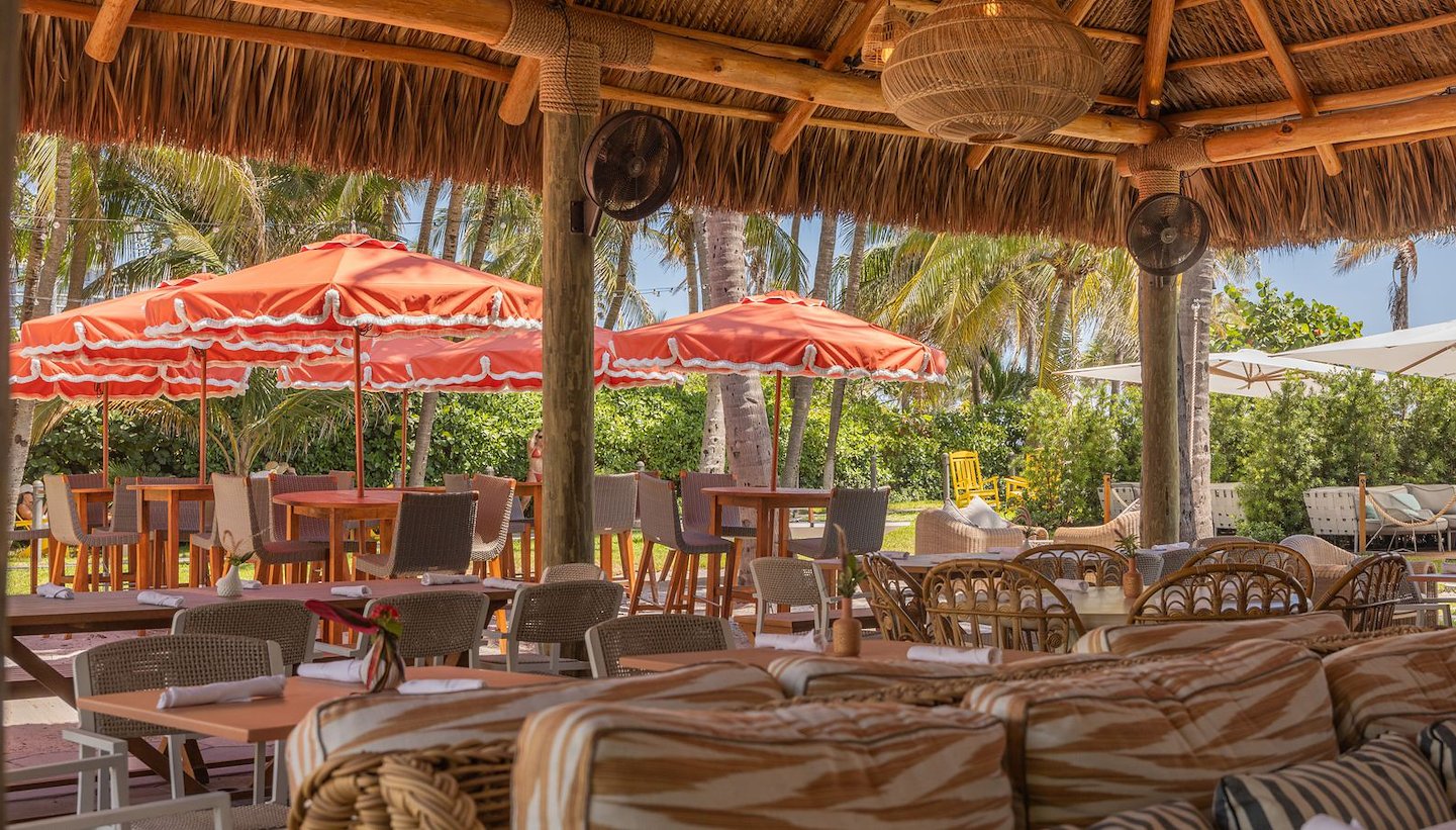 High Tide features vibrant outdoor seating with colorful umbrellas in Miami