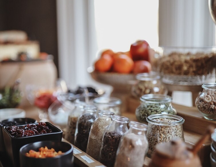 Hotel breakfast buffet with granola, fruit, seeds, and other toppings arranged in glass jars at AWOL Kennebunkport