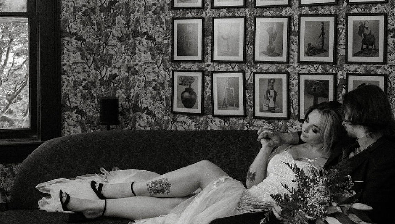 A newlywed couple relaxes on a sofa at Blind Tiger in Asheville, NC