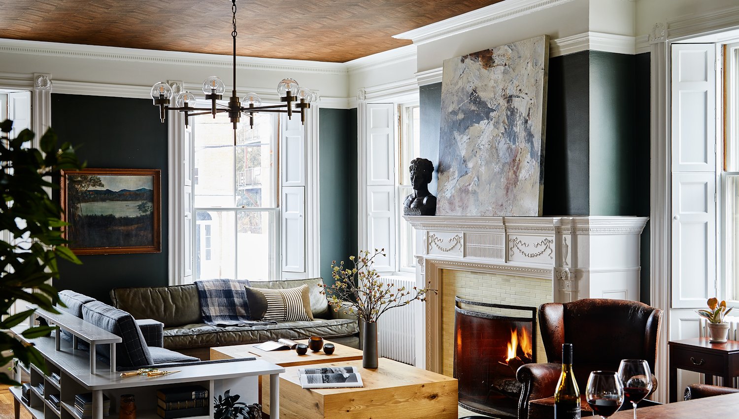 Elegant Blind Tiger lounge with a fireplace, leather seating, original architectural details and contemporary artwork.