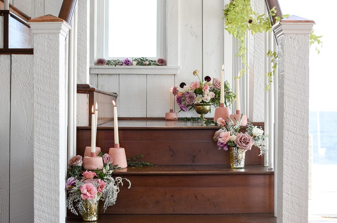 Flowers and candles decorate wooden stairs at Blue – Inn on the Beach, Newbury, MA