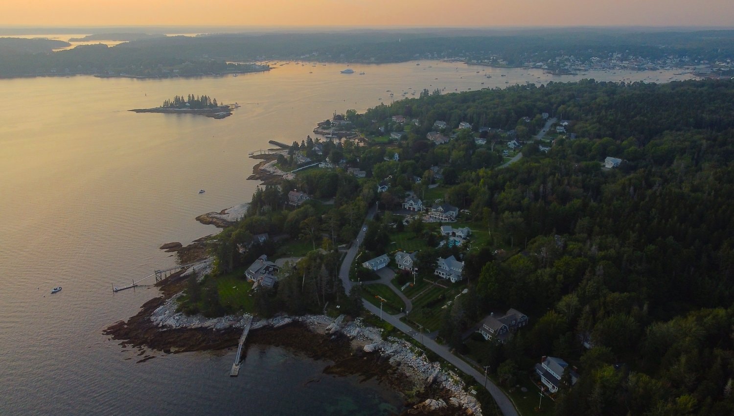 Aerial view of the coastline of East Boothbay, ME, with homes and trees.