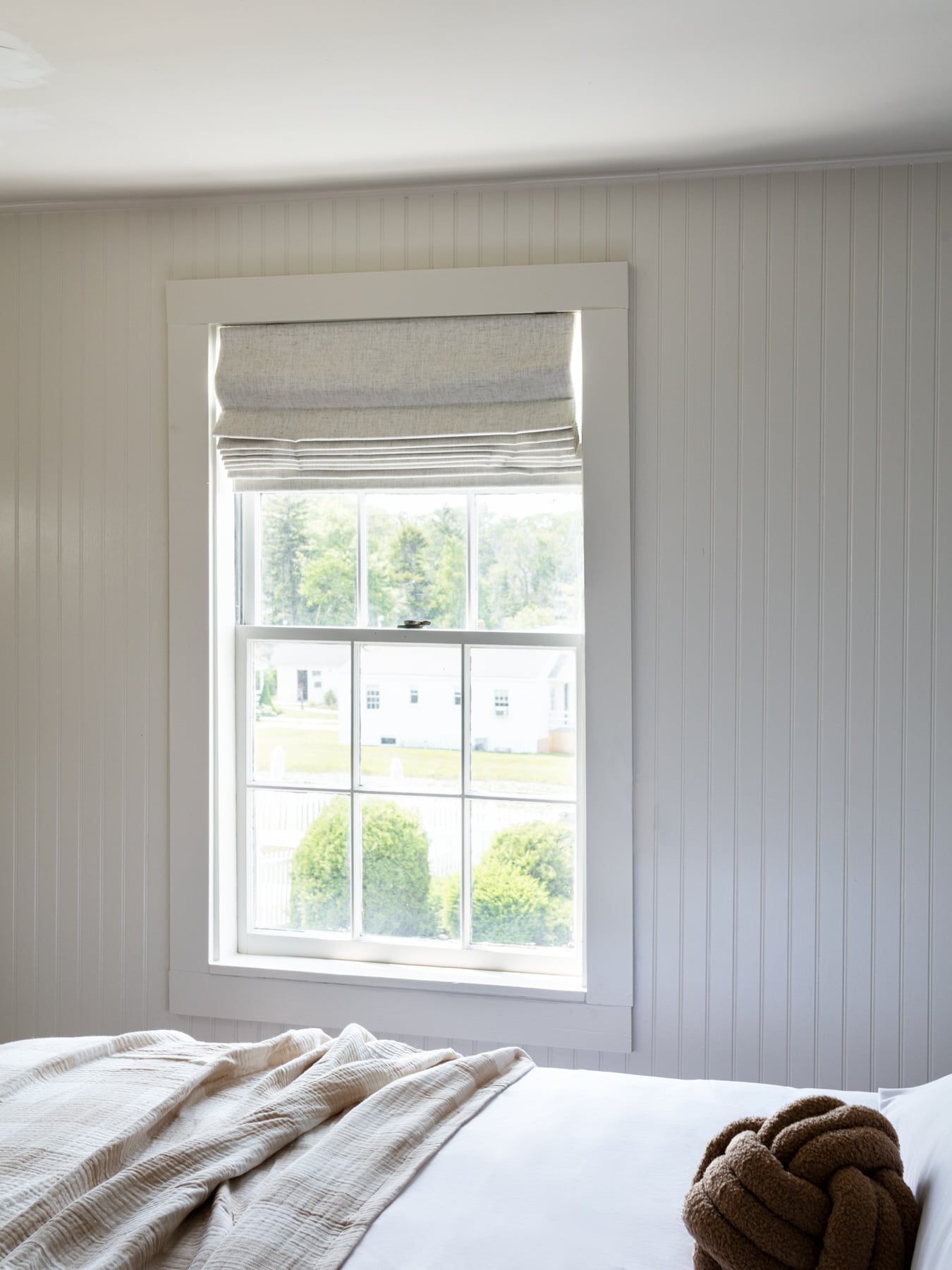 a room with a large window and a bed
