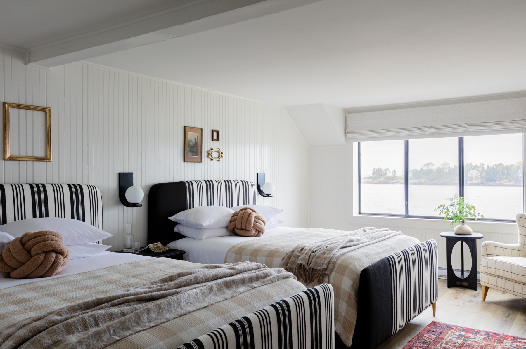 A bright and airy hotel room with two twin beds, a window with a view, and modern decor.