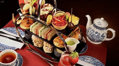 A tray of finger foods and teas on a table
