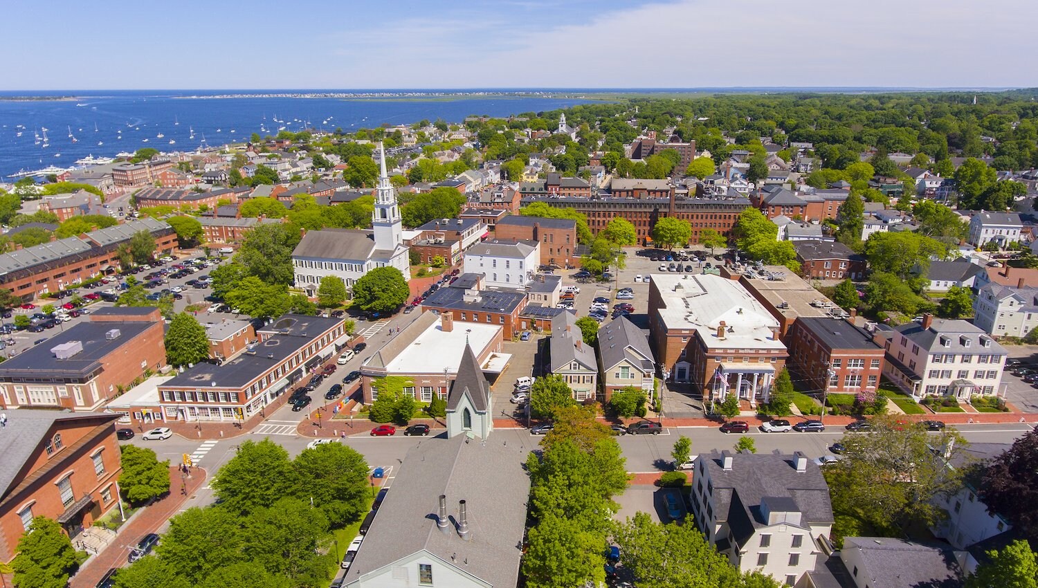 Aerial view of the Newbury Massachusetts with buildings, trees and church