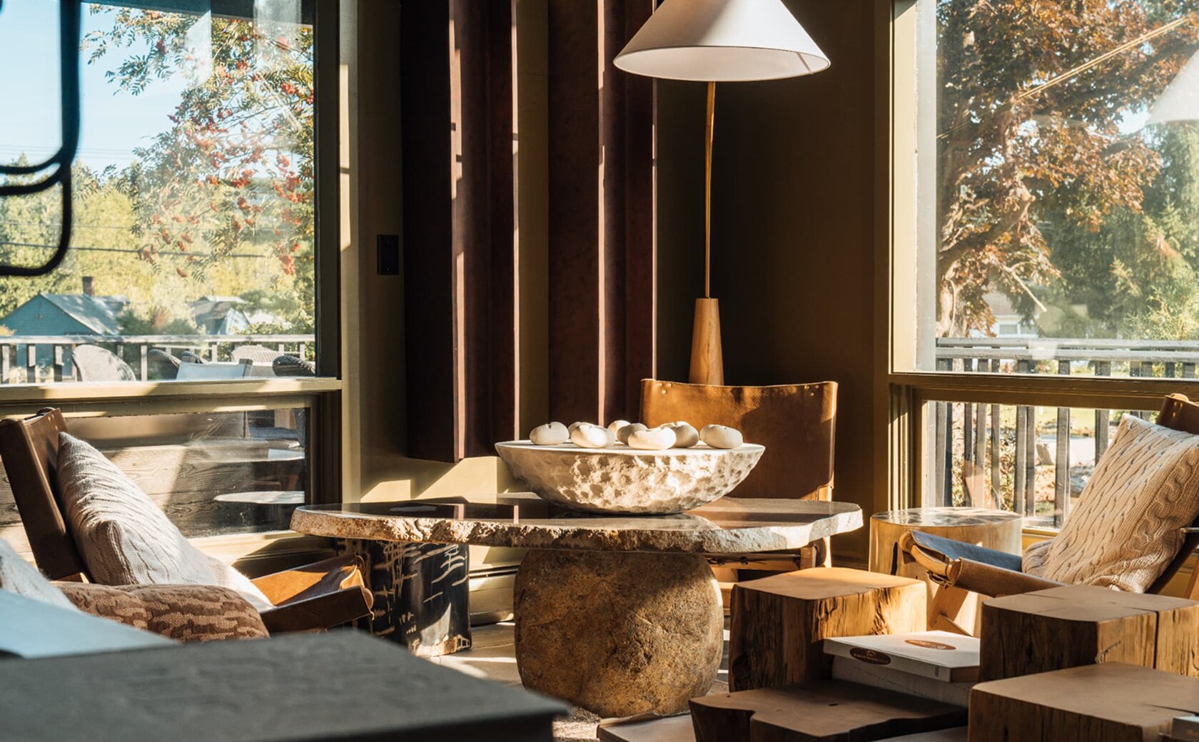 modern living room scene displaying a table and four chairs, surrounded by decorative items and soft lighting