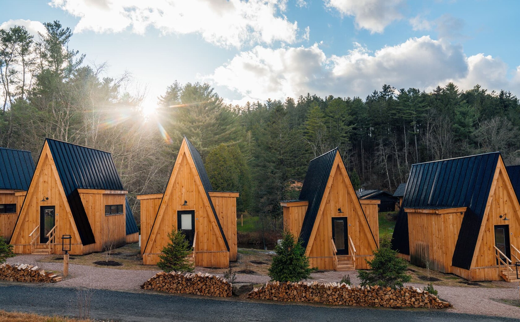 wooden cabins nestled in a natural setting, showcasing rustic architecture and a cozy atmosphere