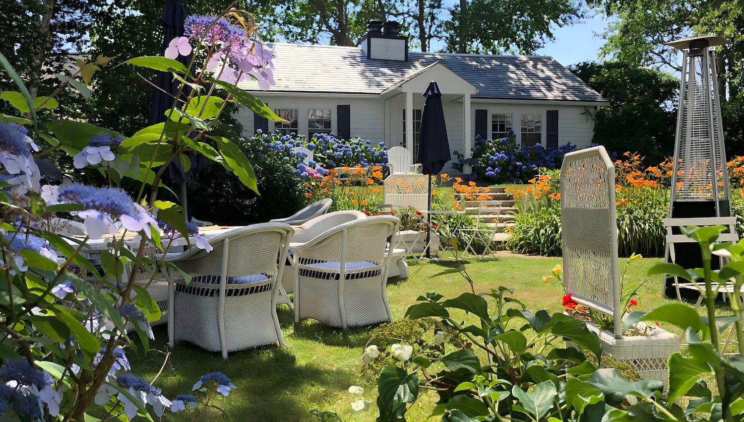 Outdoor seating area and gardens at Queen Anne Inn