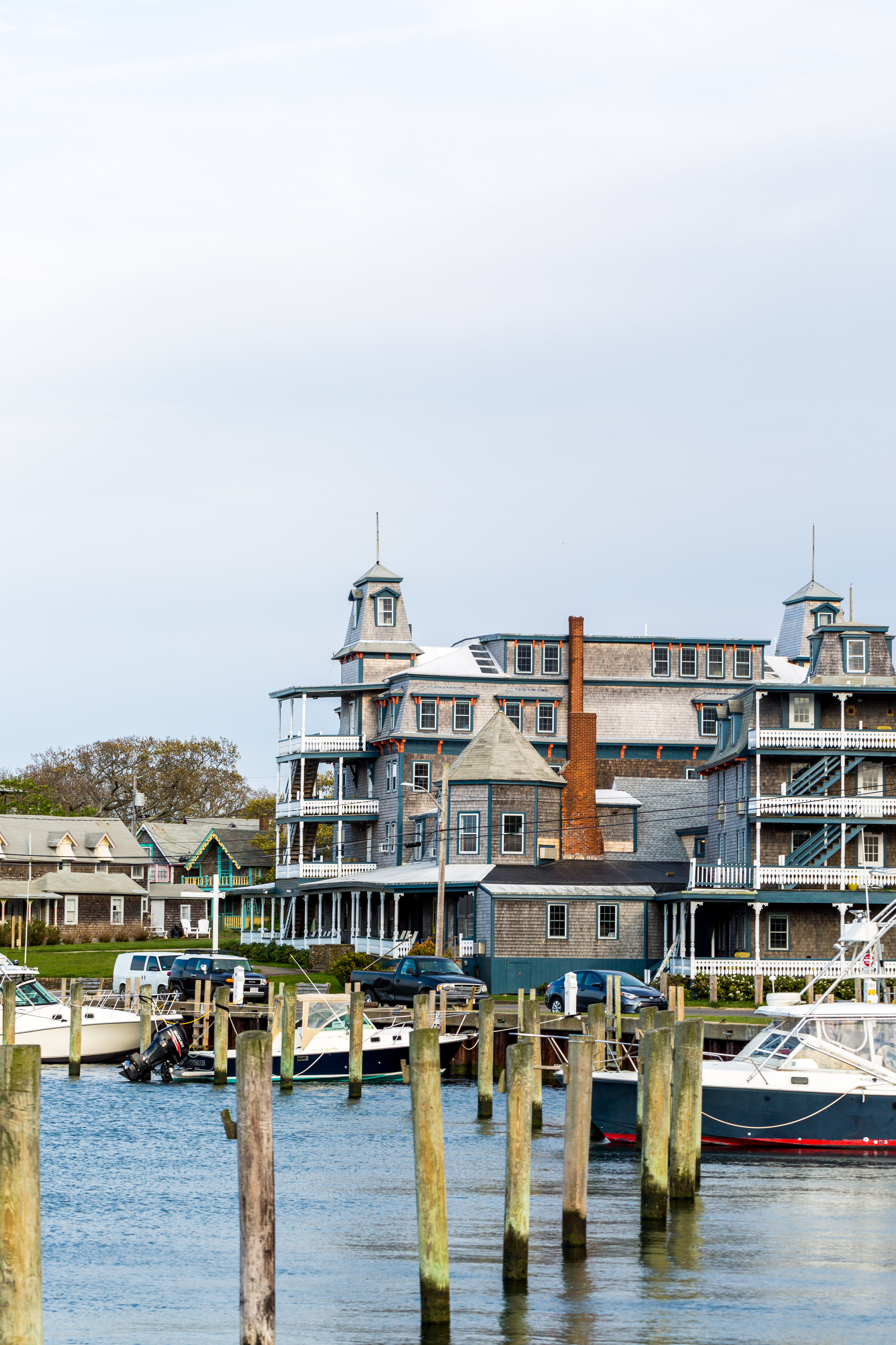 A large, multi-story building with balconies and a dock in front of it.