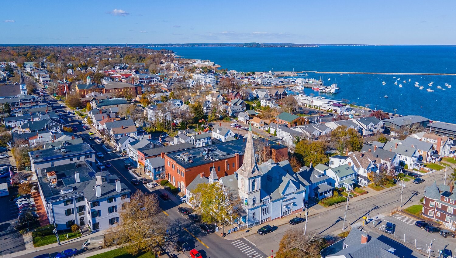 Aerial view of downtown Plymouth, MA harbor and historic church steeple