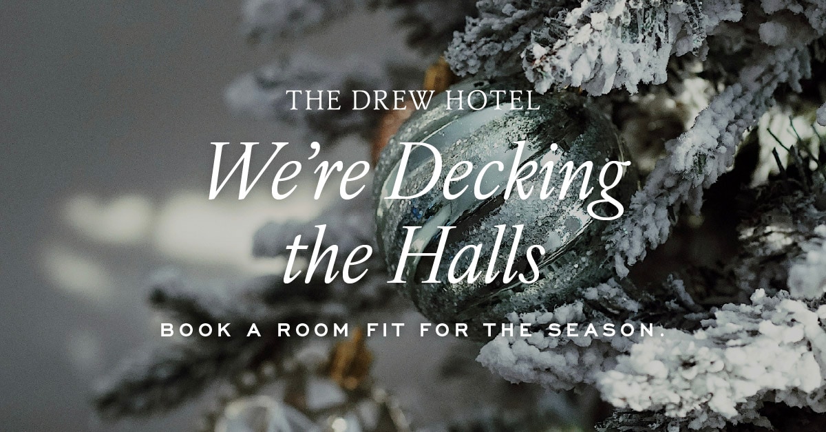 Hotel for the holidays promotion showing a snowy evergreen tree