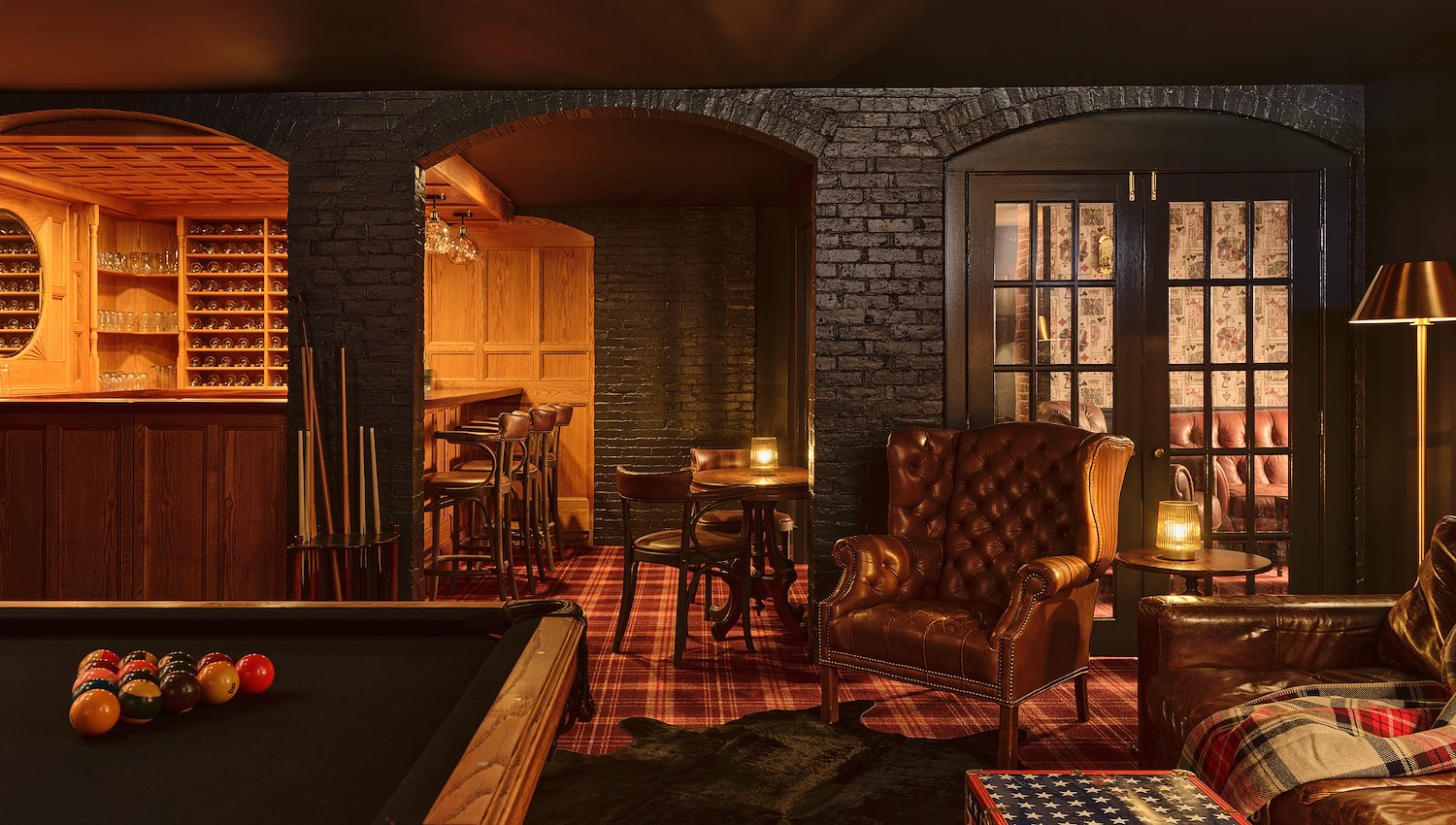 Basement bar with pool table seating and brick archways at at The Hotel Portsmouth, NH