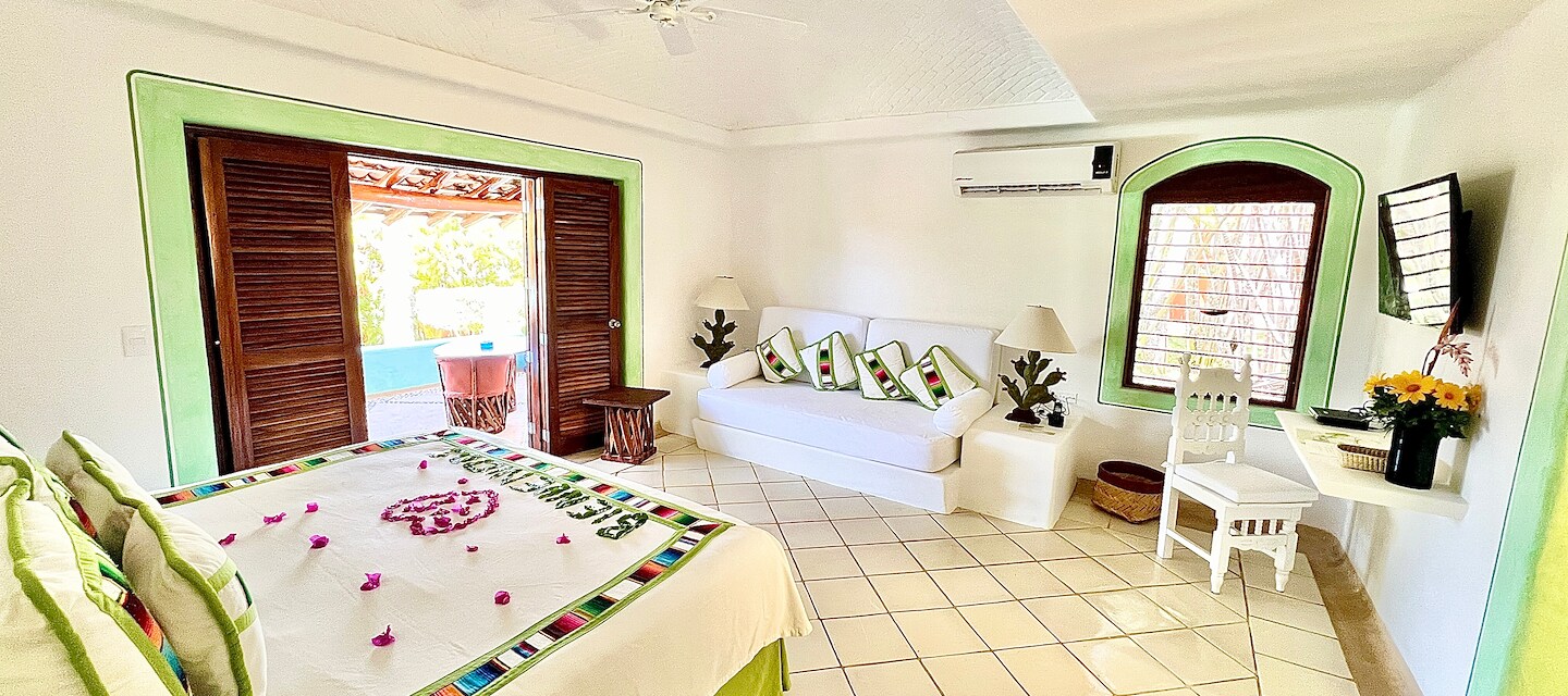 A large bedroom with a bed, a couch, and a balcony, Las Alamandas Resort, Costalegre, Jalisco